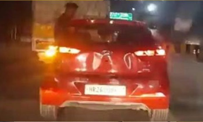 Youth Sits on Window of Speeding Car in Noida