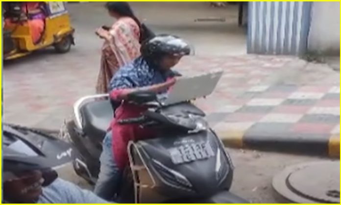 Woman working on laptop in traffic signal