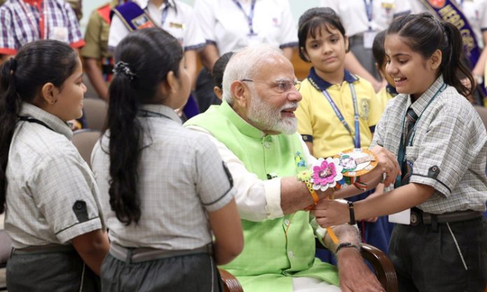 Children tie Rakhi to PM Modi